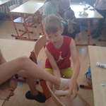 Uczeń ćwiczy prawidłowe opatrywanie stawu skokowego za pomocą bandaża.