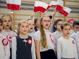 Dzieci z klas trzecich śpiewają i trzymają flagi Polski..jpg