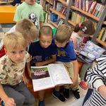 Dzieci czytają książki w szkolnej bibliotece.